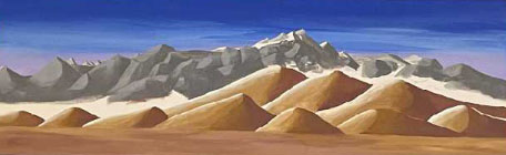 The Bradshaw Mountains — a panoramic slate ridgeline rising over the desert under a deep cobalt sky, seen from Black Canyon City, AZ